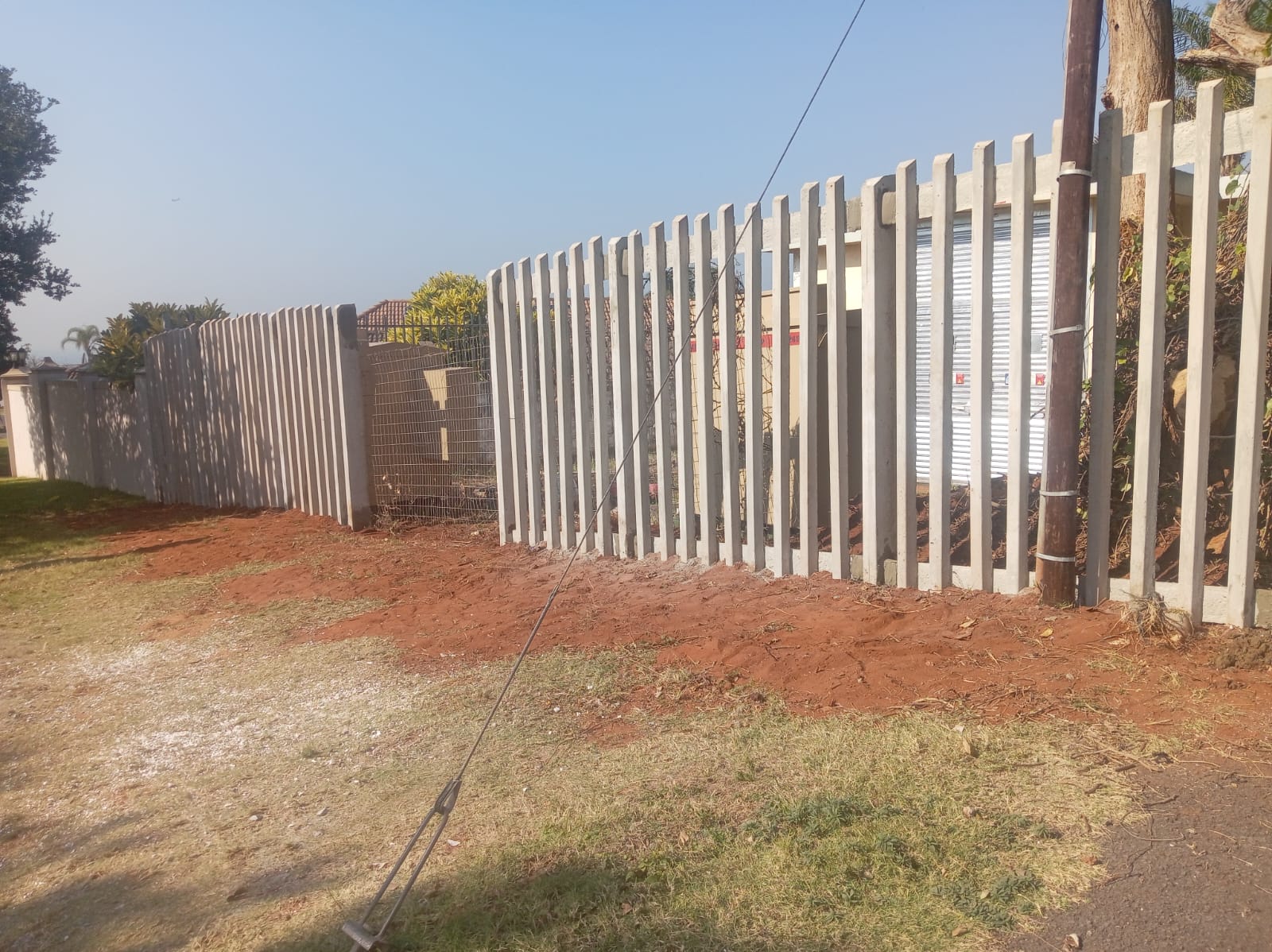 Precast concrete paling fence installed along a residential street boundary